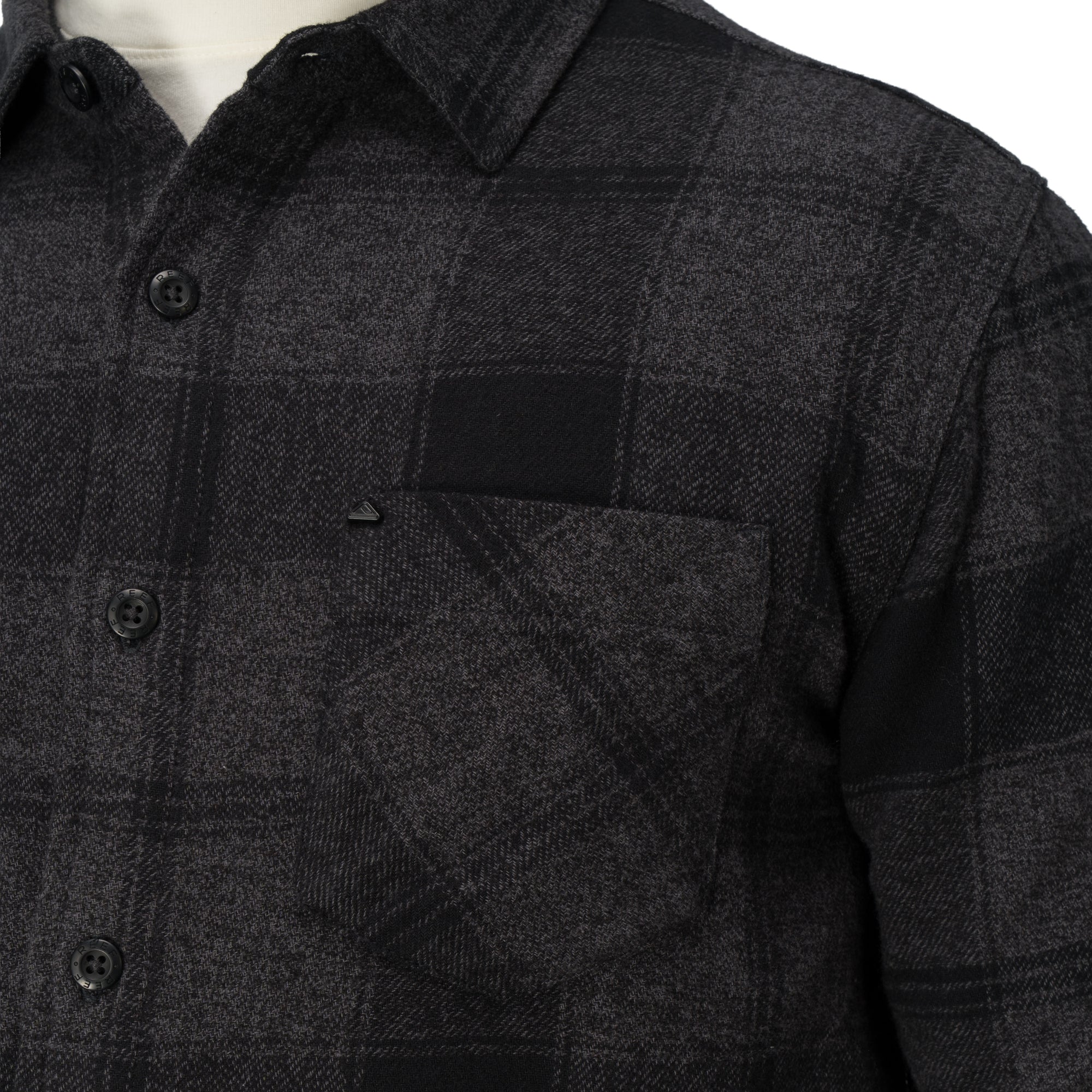 Close-up of the chest pocket and buttons on the Reggie Flannel Shirt in dark gray plaid from StoreRank.ai All Products.
