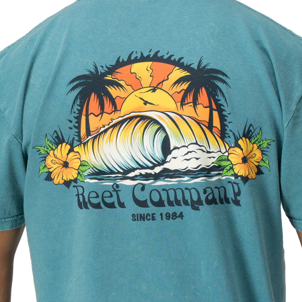 Back view of Kyle Short Sleeve Tee in sun-faded blue with vintage surf wave and palm tree graphic for beach comfort.