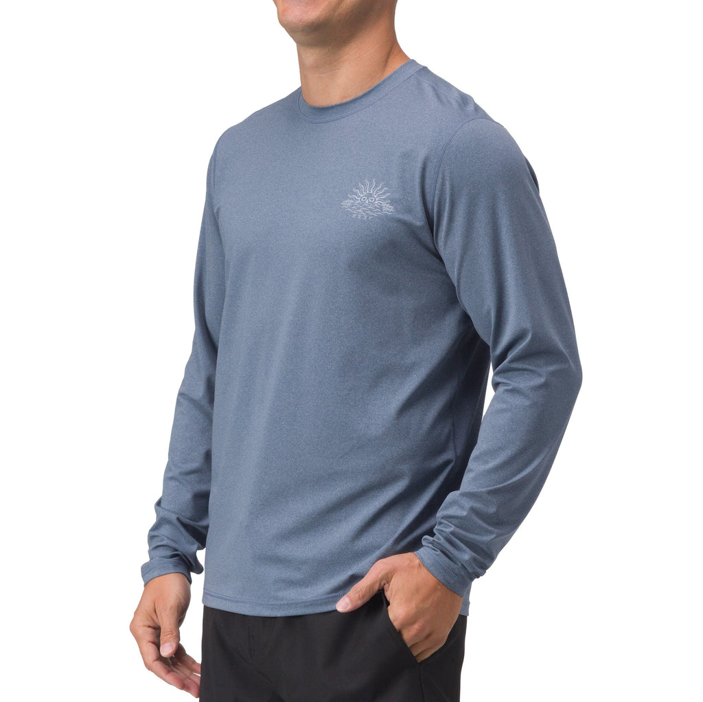 Man wearing a blue Set In Performance Shirt, long sleeve, casual fit, with subtle chest logo, front side view.
