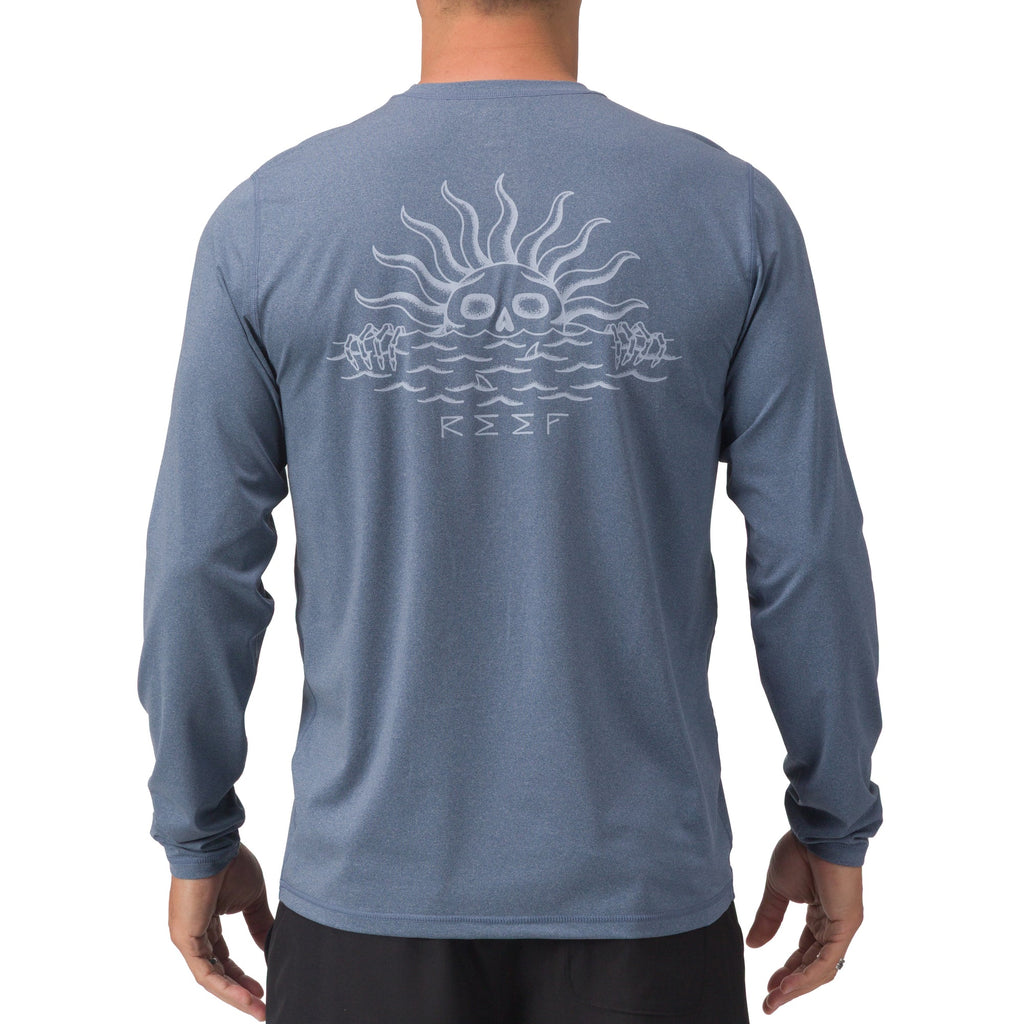 Back view of men’s Set In Performance Shirt in blue with sun skull graphic, designed for beach comfort and durability.