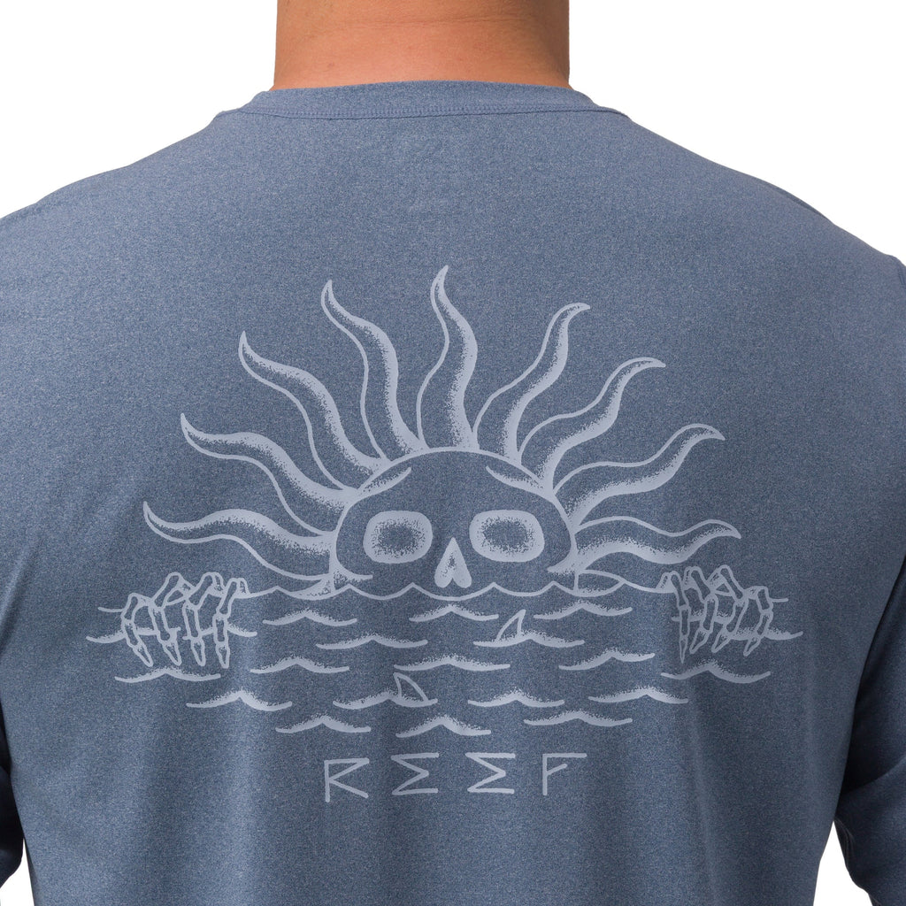 Back view of Set In Performance Shirt featuring a sun skull graphic on water, surf-inspired comfort apparel.