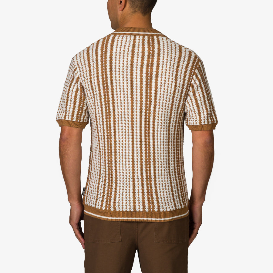 Adult wearing a surf-inspired Cabana Knit Sweater in brown and white stripes, back view, short sleeves, beach comfort style.