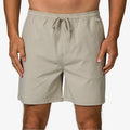 Front view of men's Rushmore Hybrid Short in beige, surf-inspired comfort apparel for beach and active lifestyles.