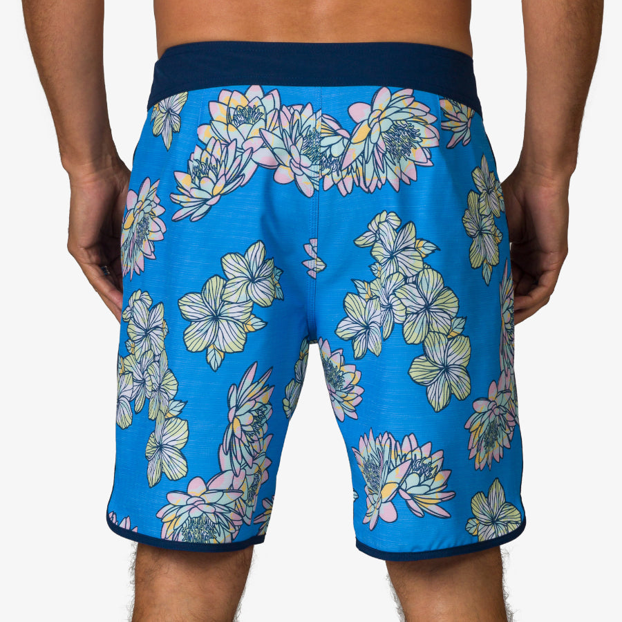 Rear view of men's Tanner Boardshort in blue with floral print, designed for beach comfort and active lifestyles.