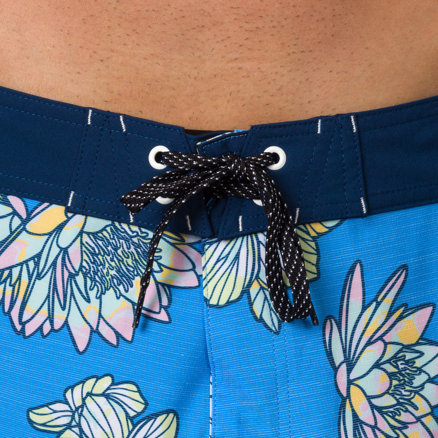 Close-up of men’s Tanner Boardshort waistband in a blue floral pattern with black and white lace tie closure