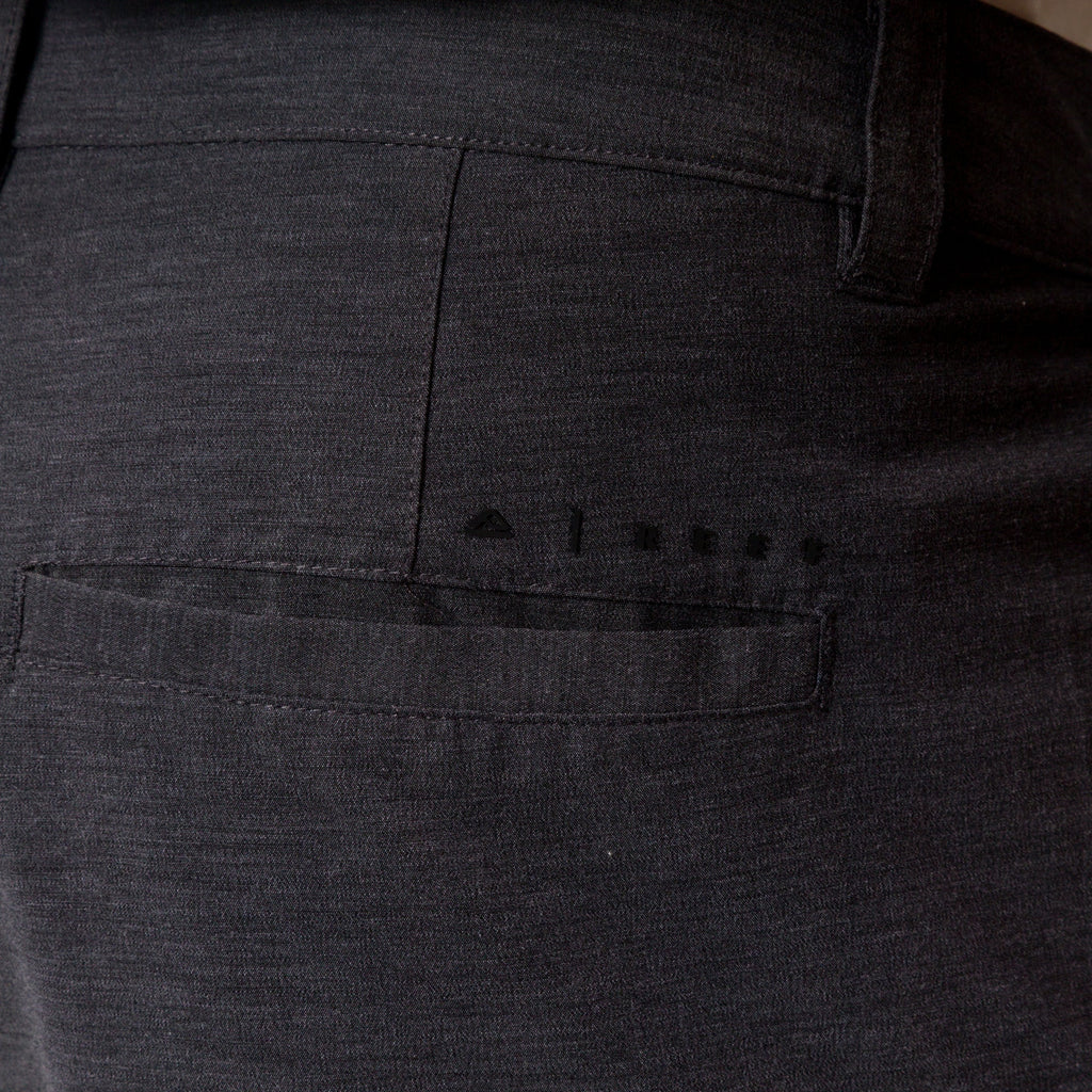 Close-up of the back right pocket of the black Destro Hybrid Short for men, showcasing breathable, comfortable beach apparel.