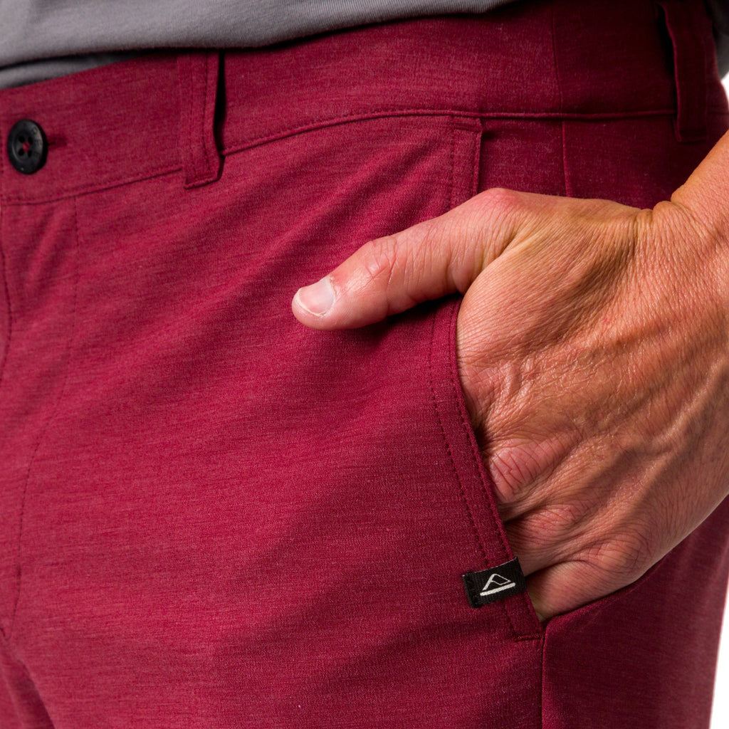 Close-up of the left front pocket and waistband of red Destro Hybrid Short worn by a man, emphasizing comfort and style.