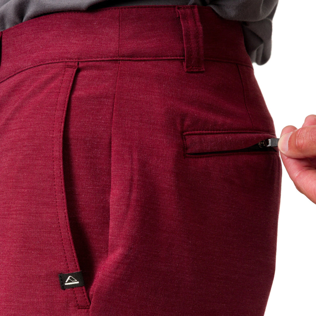 Close-up of the right side of men's Destro Hybrid Short in deep red fabric, showing zipper pocket detail.