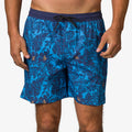 Front view of men's Felix Boardshort in blue with navy tropical leaf print and drawstring waist, beach-inspired comfort design.