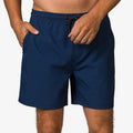 Front view of men wearing navy Garland Hybrid Short with drawstring waist and side pockets, surf-inspired comfort apparel.