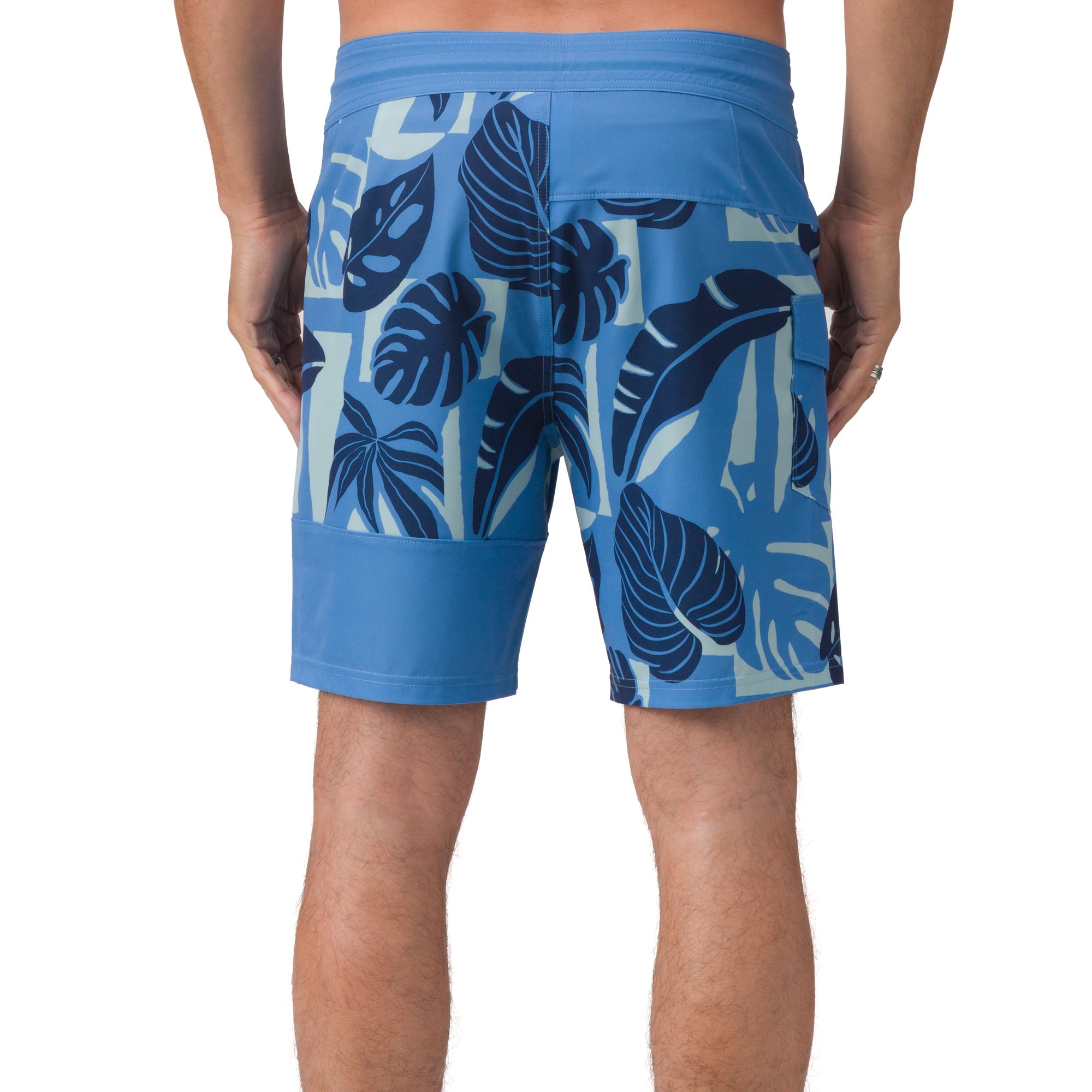 Back view of men’s Gonzo Boardshort in blue with tropical leaf print, designed for beach comfort and active lifestyle.