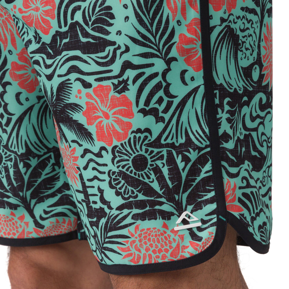 Close-up of the lower right leg of Fayder Boardshort showing vibrant floral pattern and REEF logo facing forward.