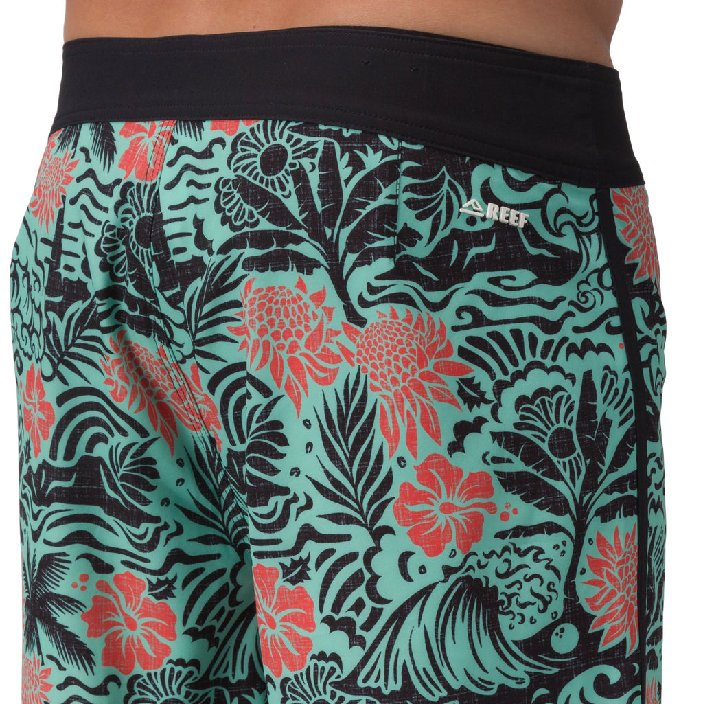 Close-up of the front left side of Fayder Boardshort featuring tropical print and black waistband for beach comfort.