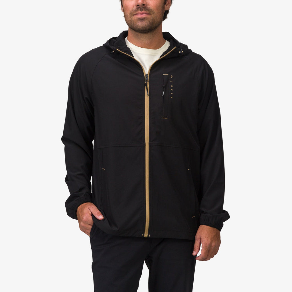 Front view of a man wearing the Garvey Full Zip Jacket in black, surf-inspired comfort and water-friendly design.