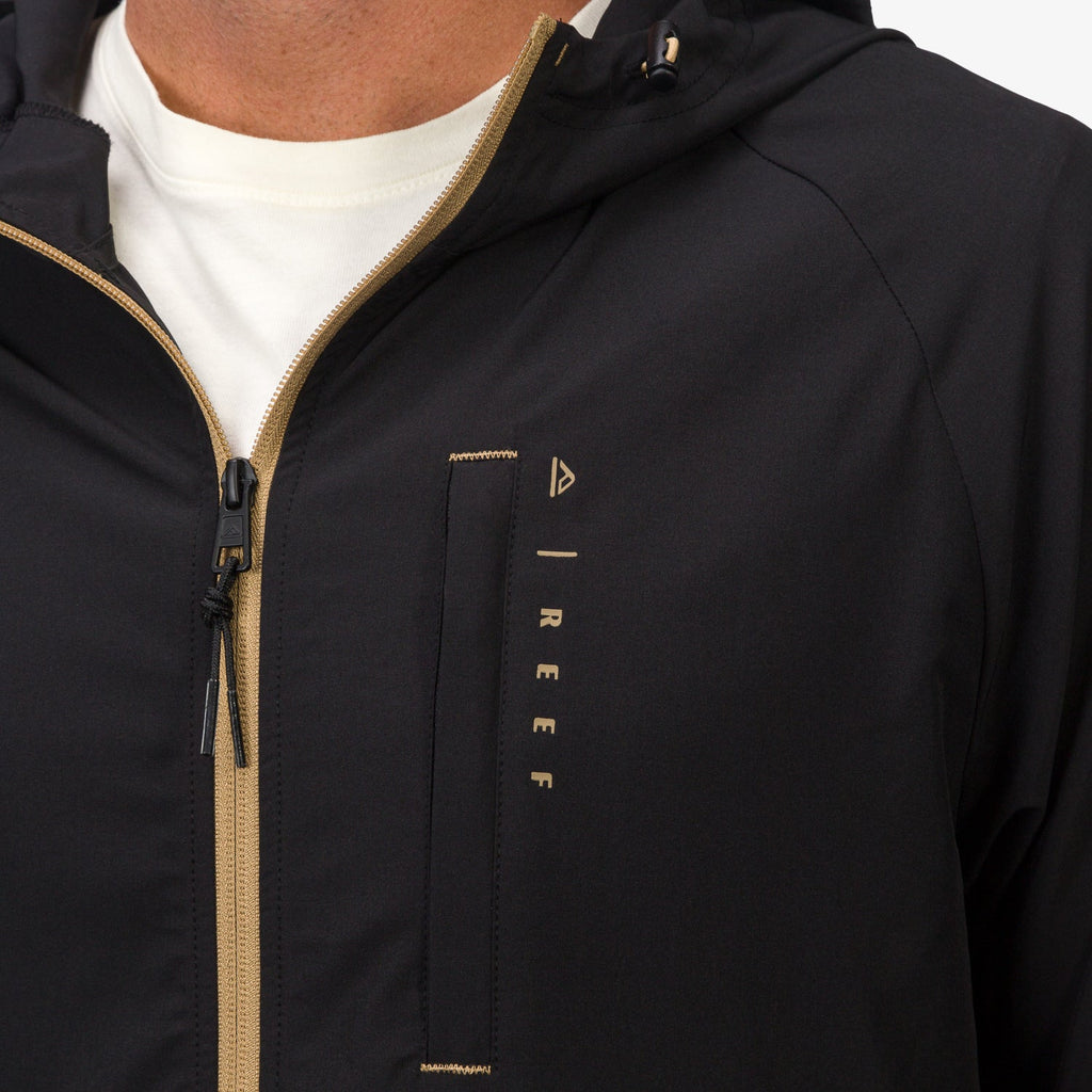 Close-up of the front upper section of the men's Garvey Full Zip Jacket with contrast zipper and REEF logo.