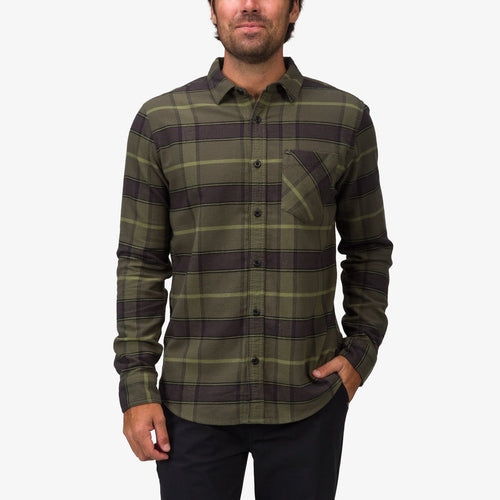 Front view of a man wearing the Anders Long Sleeve Woven Shirt in olive plaid, pocket visible, styled casually with black pants