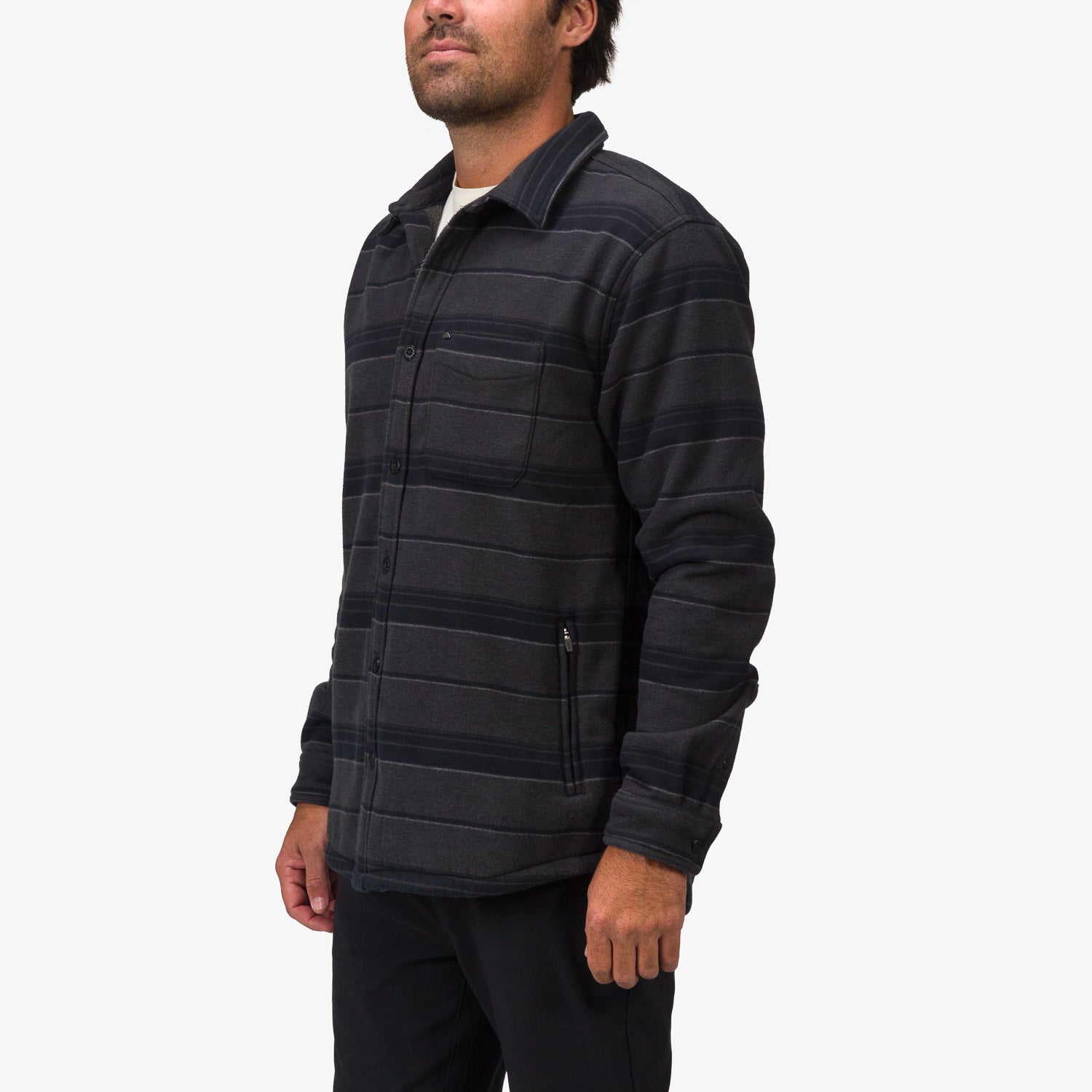Man facing left wearing a Bartlett Woven Jacket in dark striped fabric, showcasing comfort-focused beach-inspired apparel.