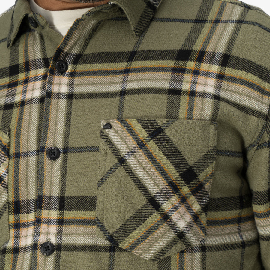 Close-up of the chest pocket and upper front of the Dyson Flannel Shirt in green plaid, comfort-focused beach apparel.