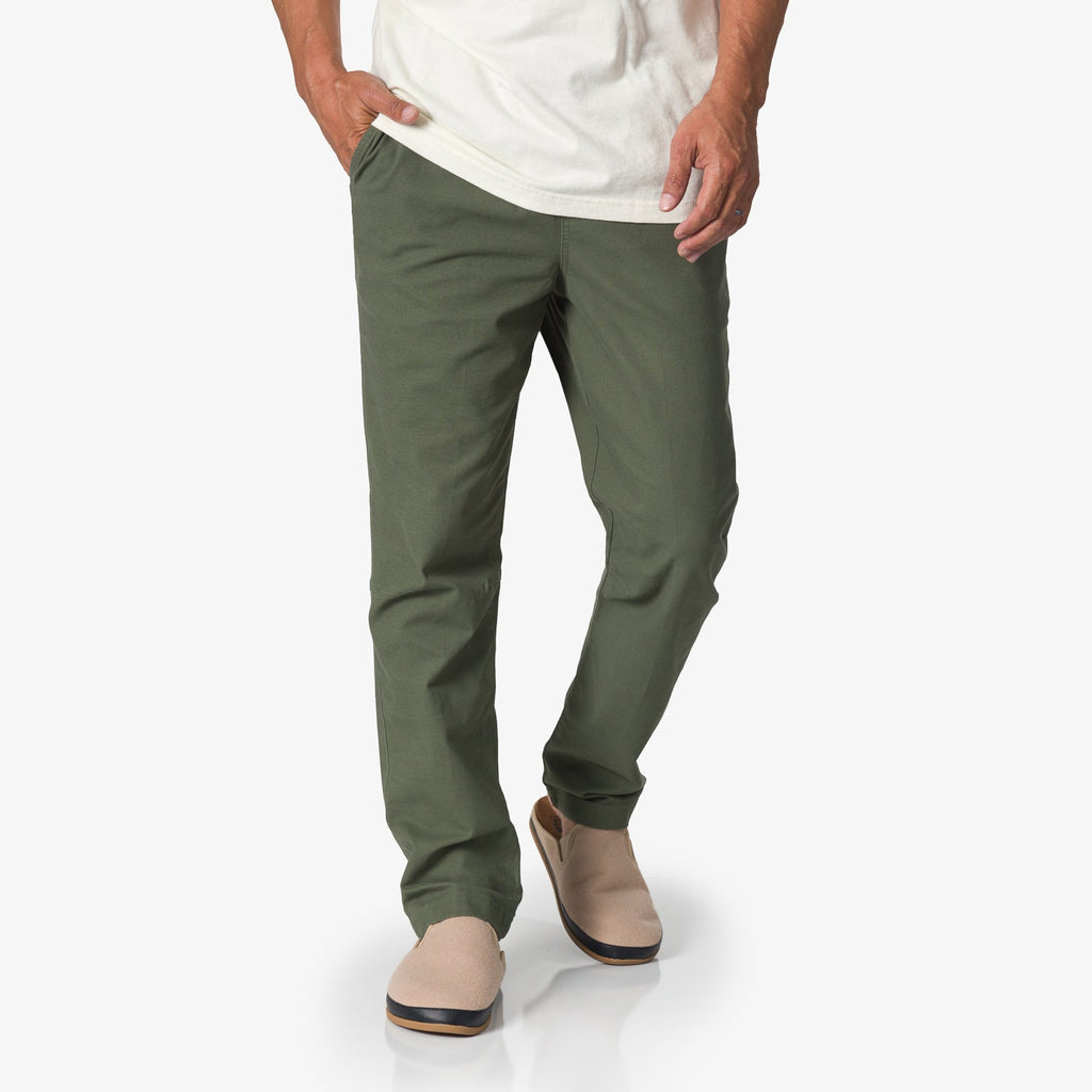 Men wearing Matthew Twill Pant in olive green, with beige shoes facing forward, showcasing comfort and casual style.