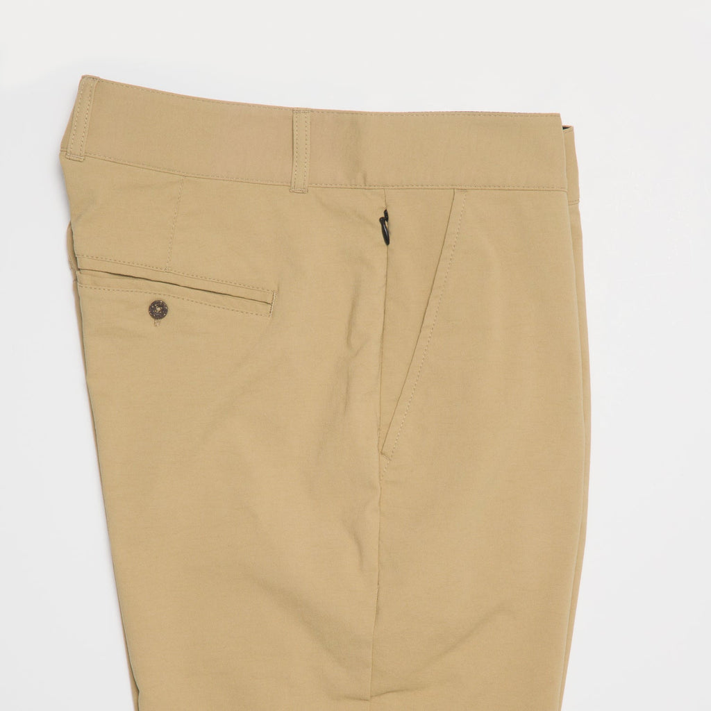 Close-up of the waist and upper thigh area of tan Carrick Stretch Pant for men, highlighting durable fabric and clean design.
