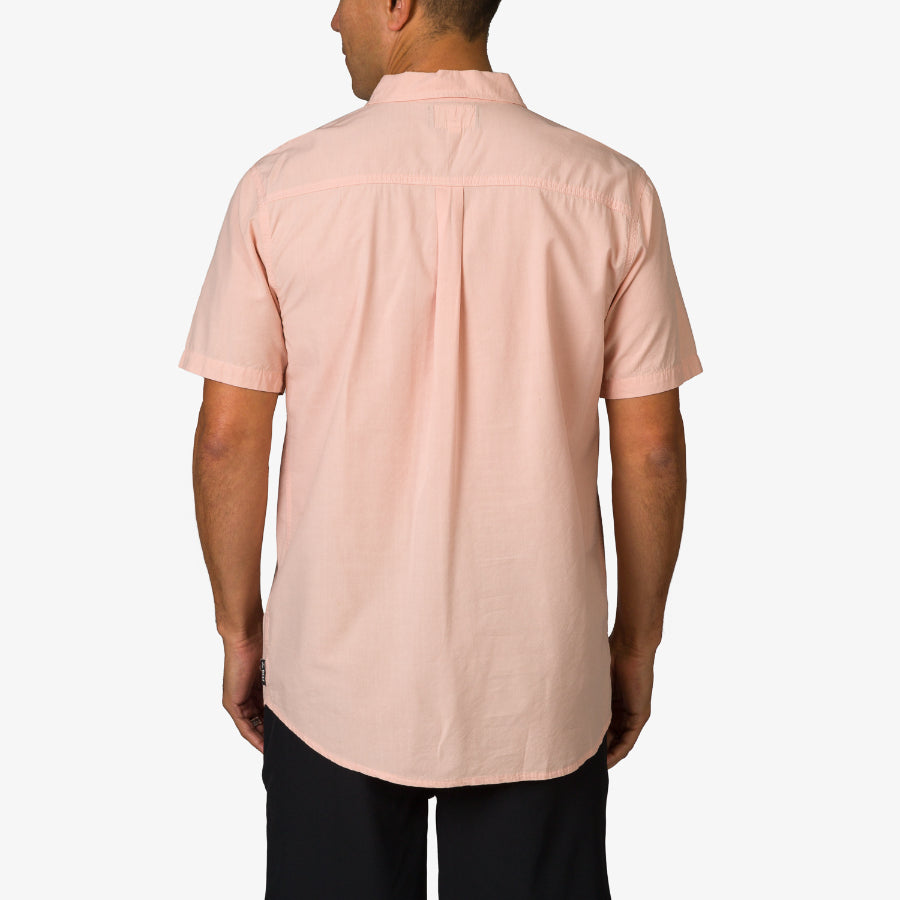 Man wearing a light pink Collins Ss Woven Shirt showing the back, casual beach-inspired men’s apparel