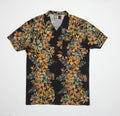 Drift Ss Camp Shirt with black base and vibrant orange floral print, short sleeves, and relaxed beach-inspired fit.