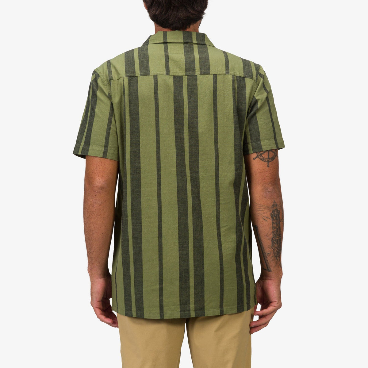 Man wearing Angelo Short Sleeve Camp Shirt in green vertical stripes, back view, casual beach-inspired apparel design.