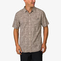 Man wearing Ferris Classic Shirt with beige geometric pattern, front view, styled for beach comfort and active lifestyle.