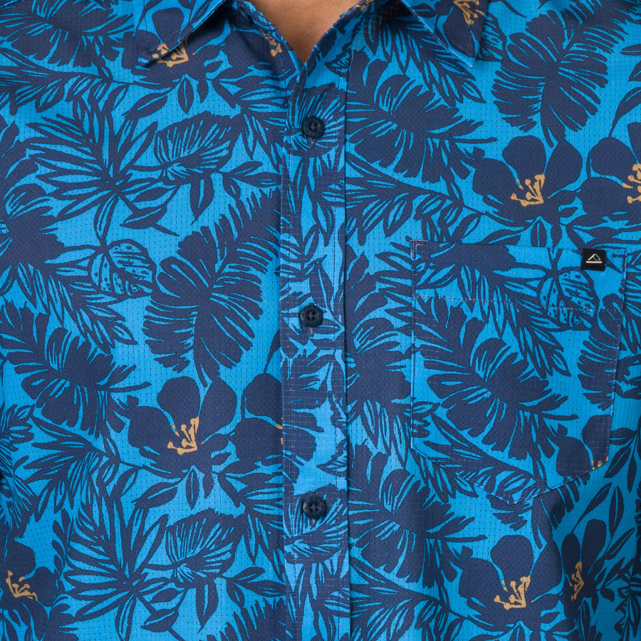 Close-up of the front chest pocket and buttons on the Tyson Classic Shirt in blue tropical print for men’s apparel.