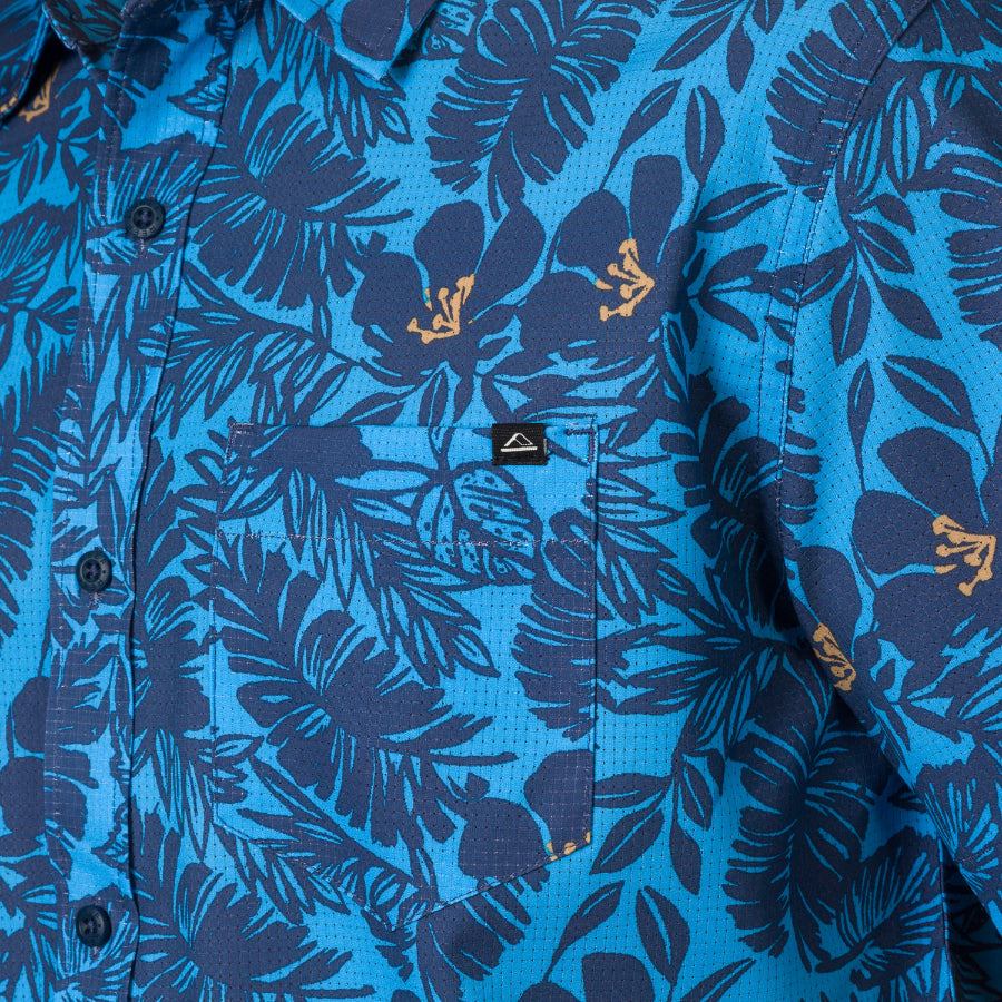 Close-up of the chest pocket on the Tyson Classic Shirt with blue tropical floral print for men’s beachwear.