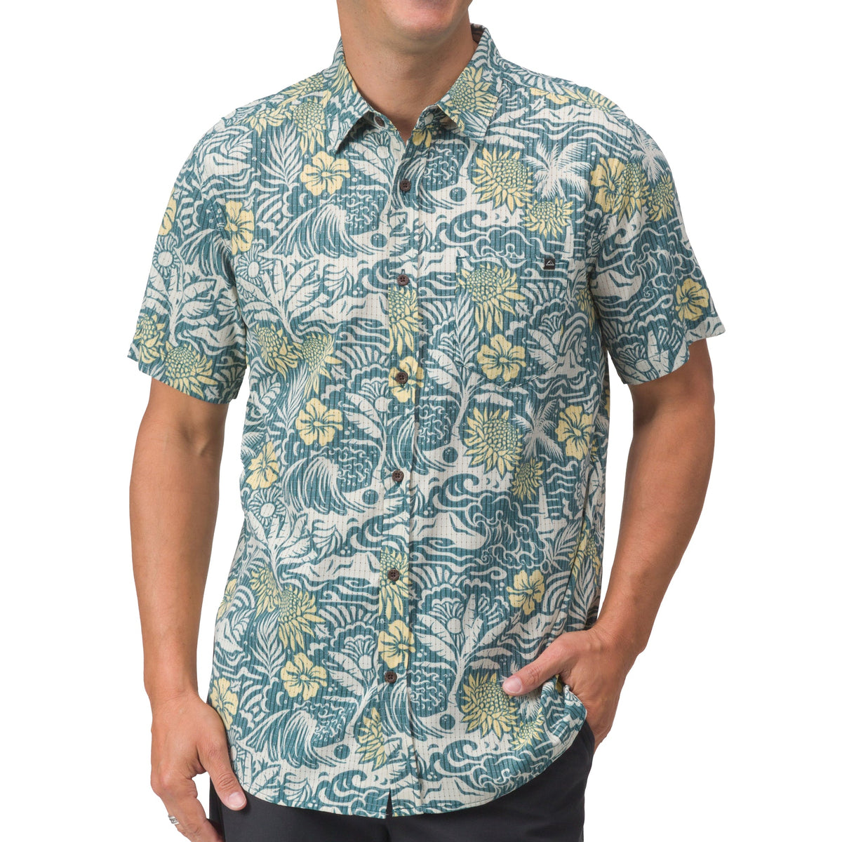 Man wearing a blue and yellow floral patterned short-sleeve Eugene Woven Shirt, front view with hand in pocket.
