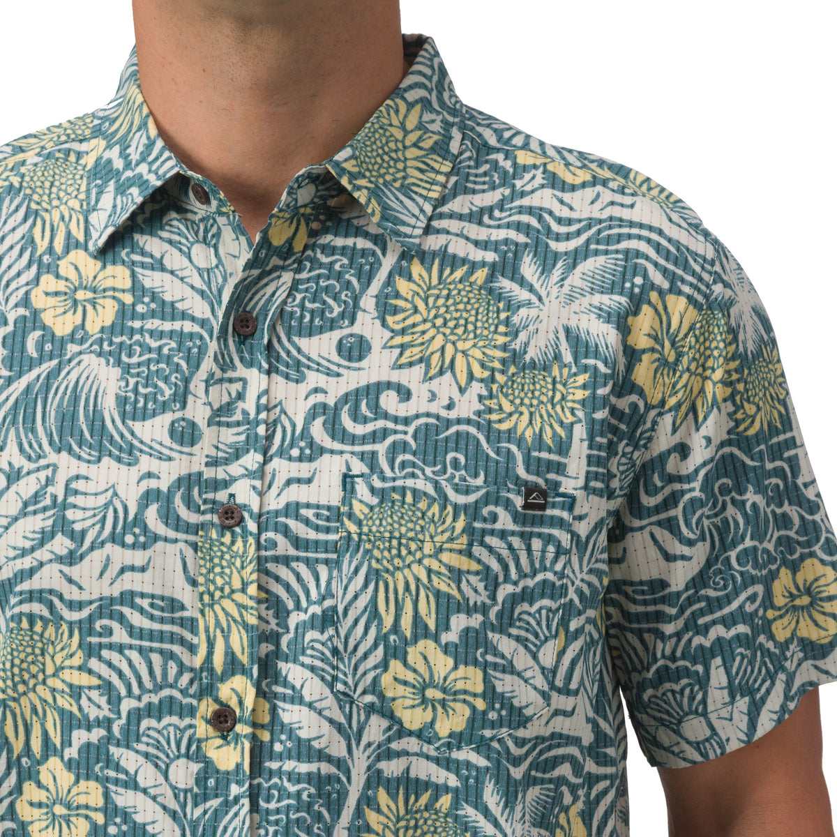 Close-up of the front chest and collar of the men’s Eugene Woven Shirt in a blue and yellow tropical pattern.