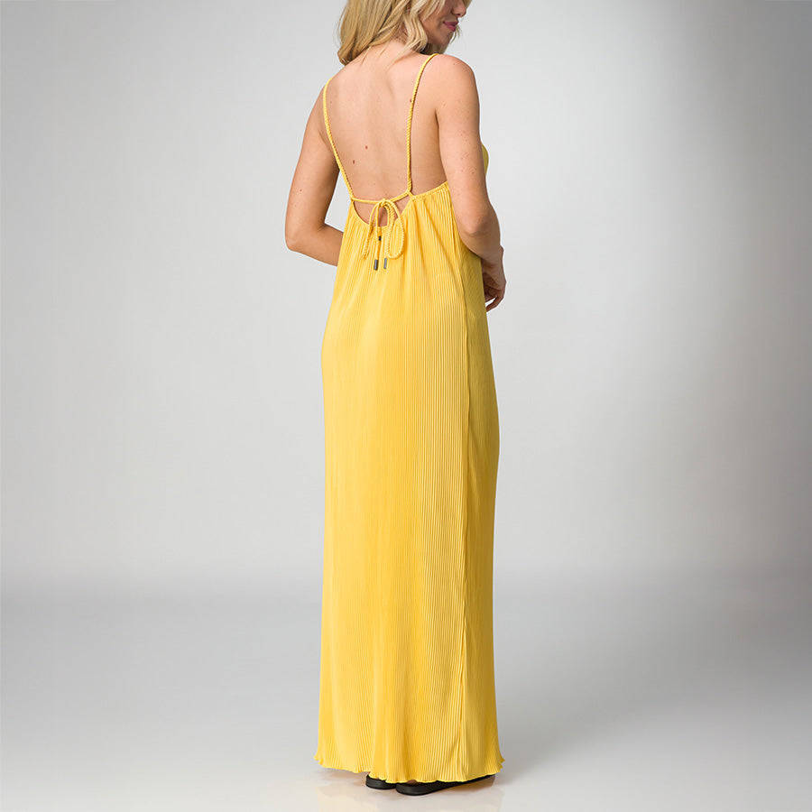Woman wearing a yellow Plisse Dress shown from the back with spaghetti straps and a tie detail, lightweight beach-inspired apparel.