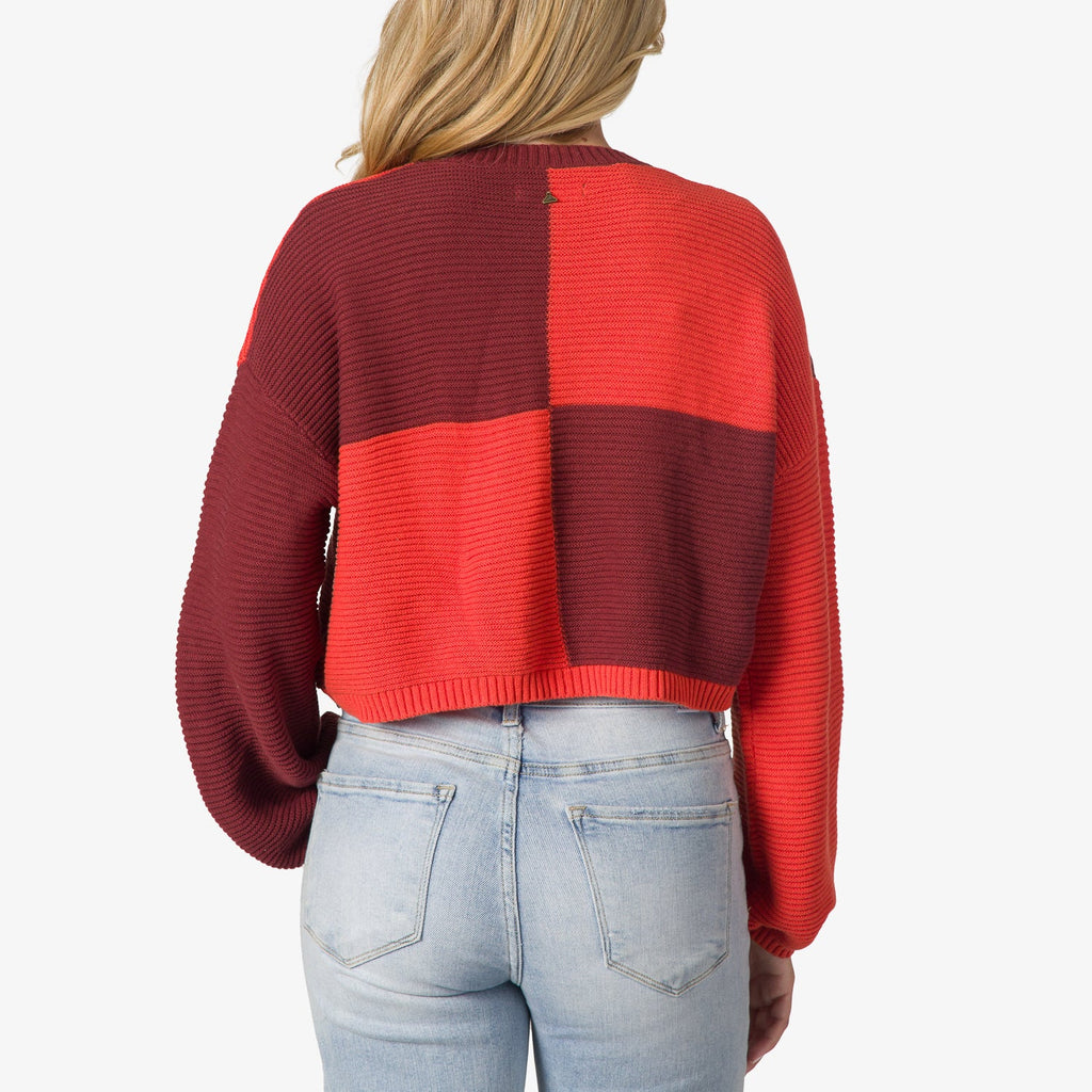 Rear view of Carrie Sweater in red and burgundy block colors, showing knit texture and relaxed fit on model.