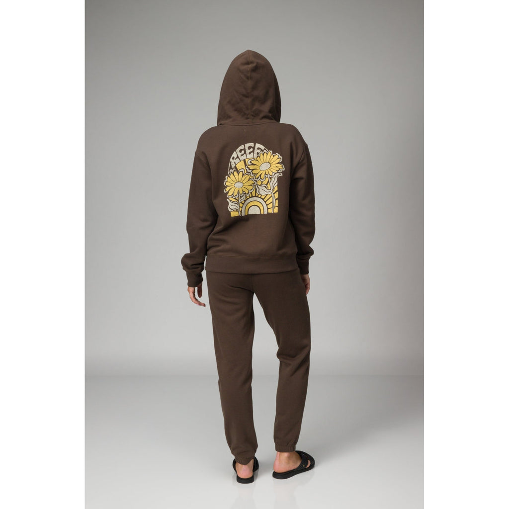 Person wearing brown Misty Fleece Full Zip hoodie back view with floral and rainbow design, paired with comfortable black sandals facing back