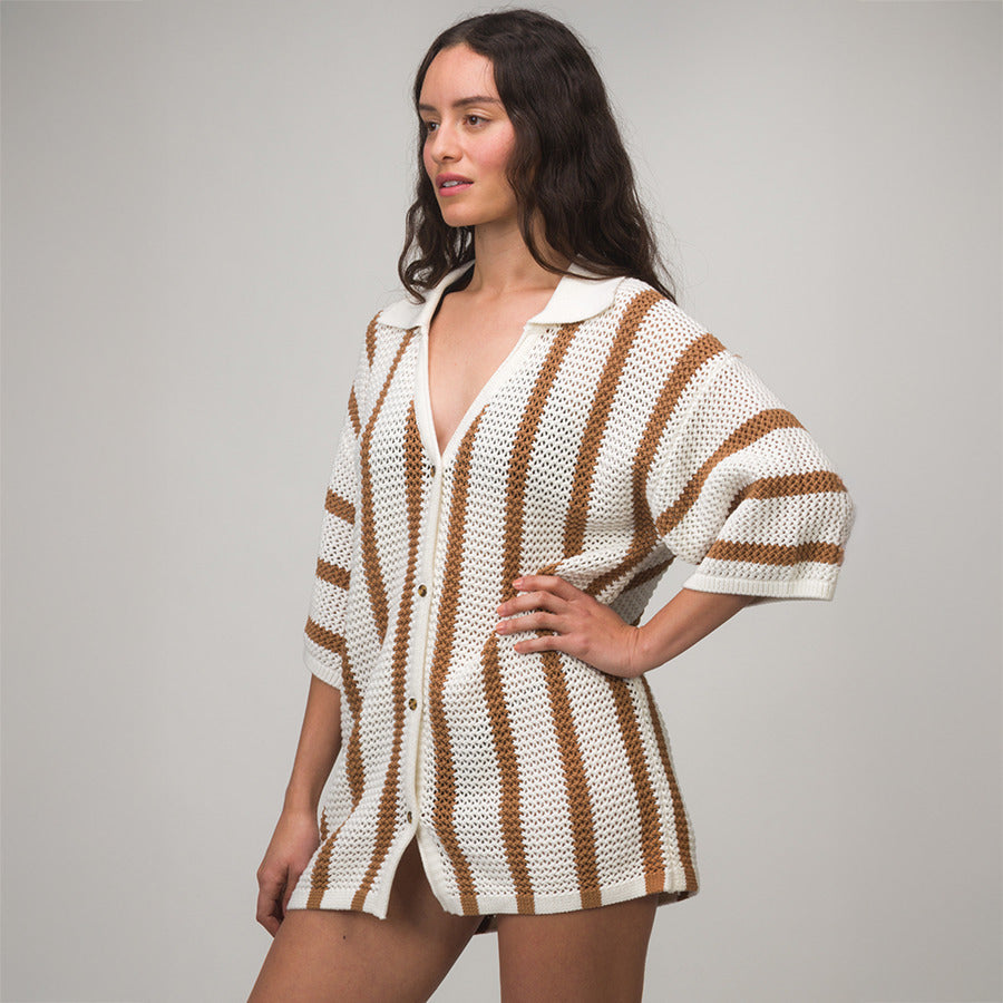 Woman wearing Mika Button Down Top with brown and white stripes, relaxed fit, beach-inspired comfortable apparel for everyday use.