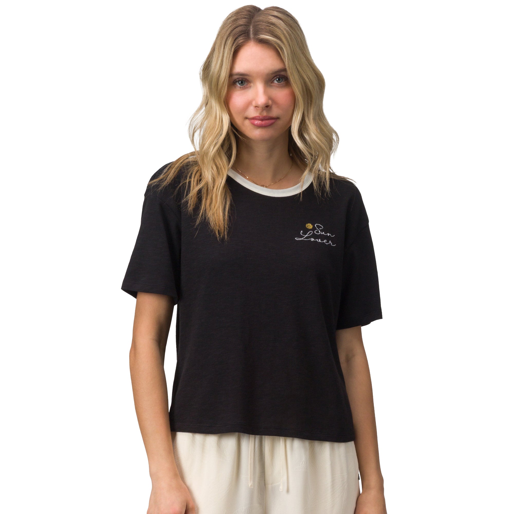 Woman wearing a black Sun Lover Ringer Tee with white collar and small chest logo, front view, beach-inspired comfort apparel.