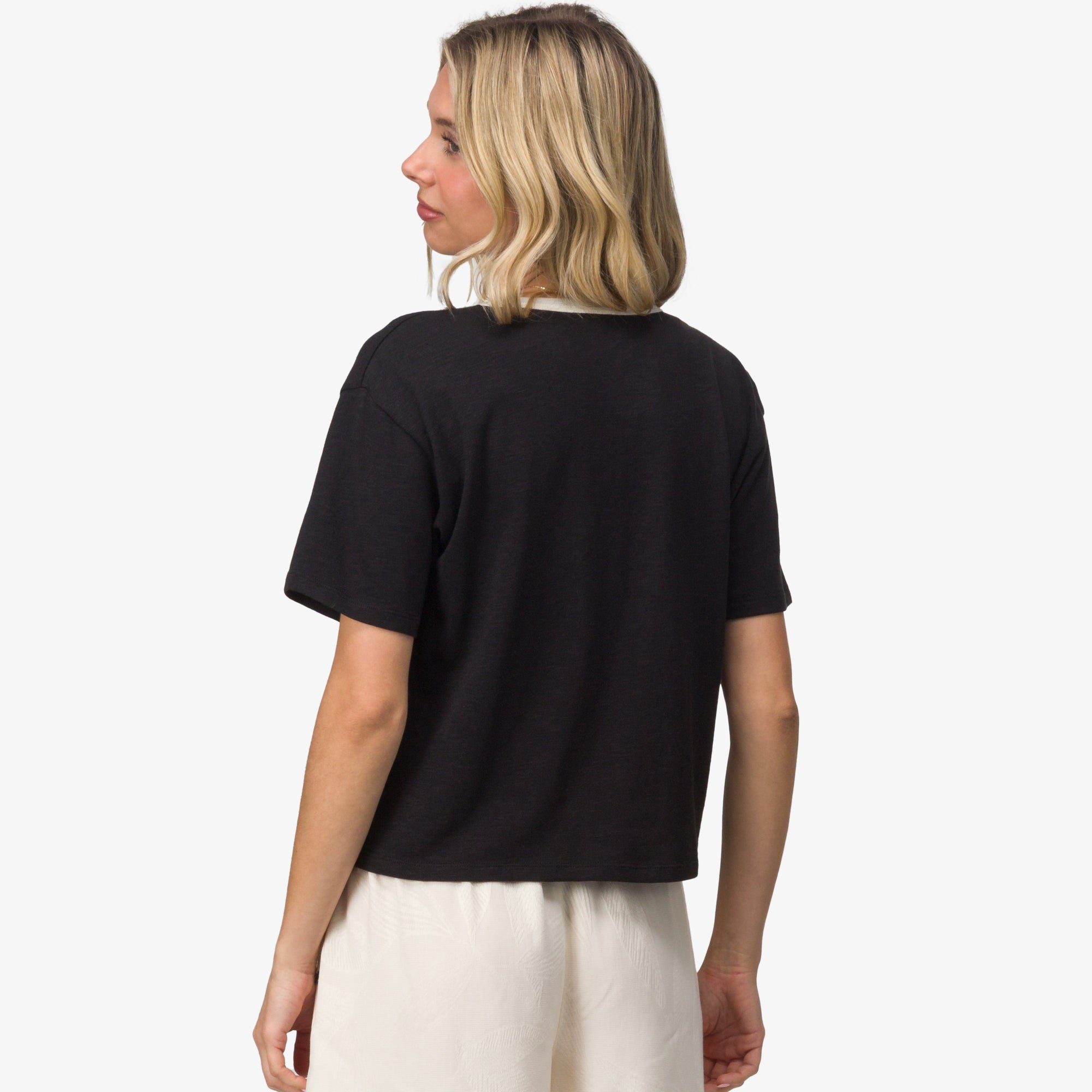 Woman wearing black Sun Lover Ringer Tee shown from back, highlighting comfortable, casual beach-inspired apparel.