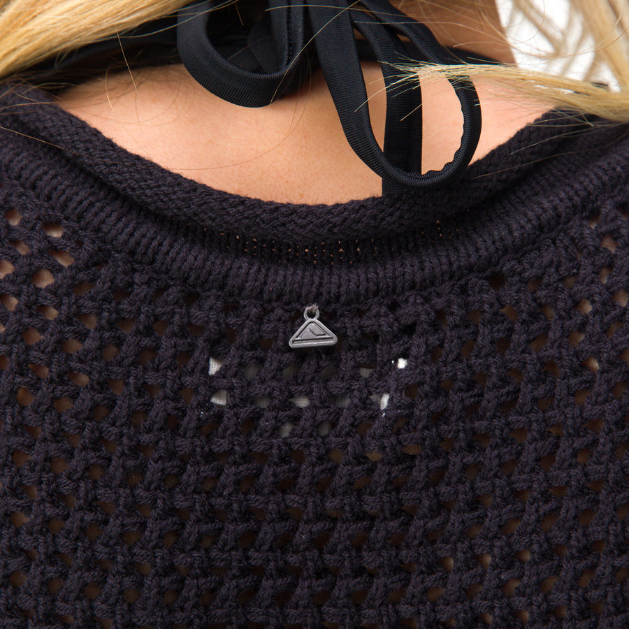 Close-up of the back neckline of the Mika Sweater Tank showing black knit fabric and REEF logo detail, beach-inspired comfort.