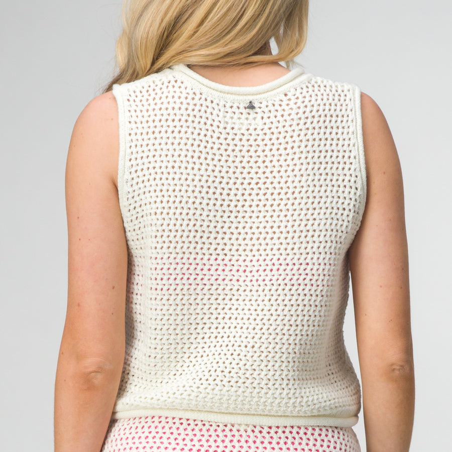 Back view of woman wearing Mika Sweater Tank, beach-inspired lightweight and breathable knit apparel for comfort.