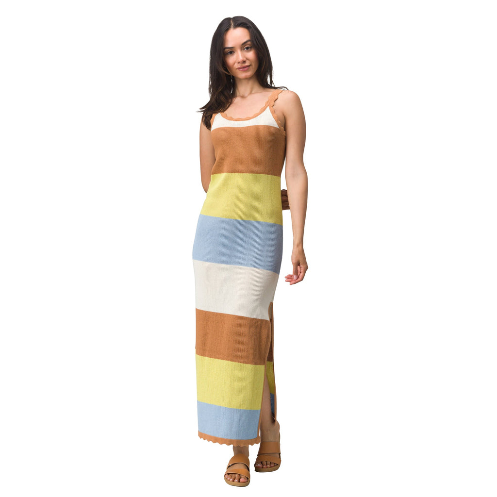 Woman wearing a Gia Maxi Dress with wide horizontal stripes in tan, yellow, blue, and cream, styled for beach comfort and active lifestyles.