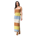 Woman wearing a Gia Maxi Dress with wide horizontal stripes in tan, yellow, blue, and cream, styled for beach comfort and active lifestyles.