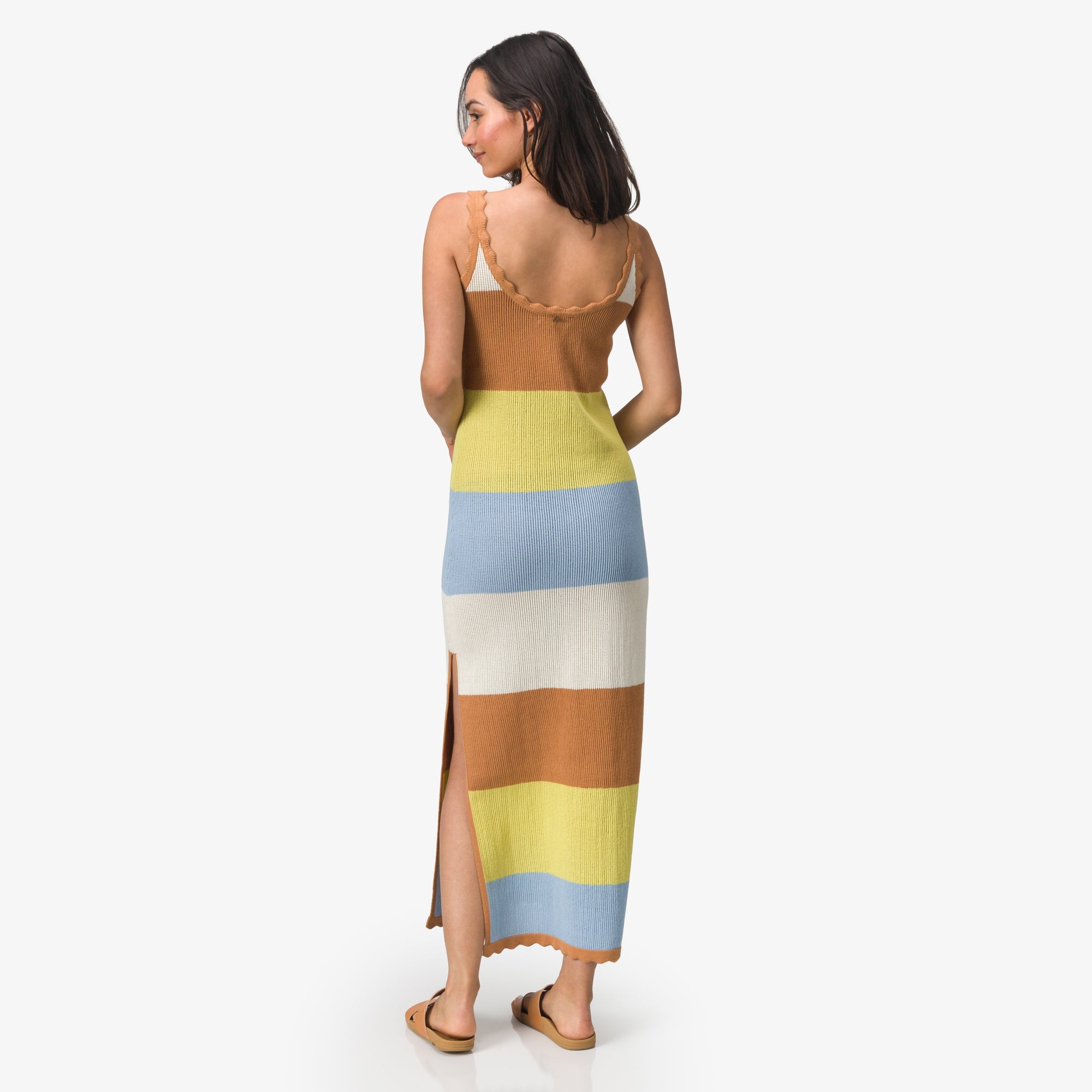 Woman wearing a striped Gia Maxi Dress facing away, showcasing the back design and beach-inspired comfort style.