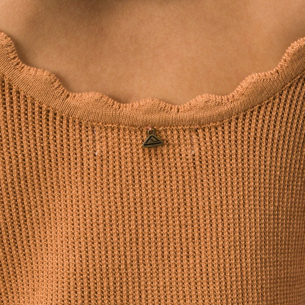 Close-up of the scalloped neckline detail on the Gia Maxi Dress in soft knit fabric, featuring surf-inspired comfort.
