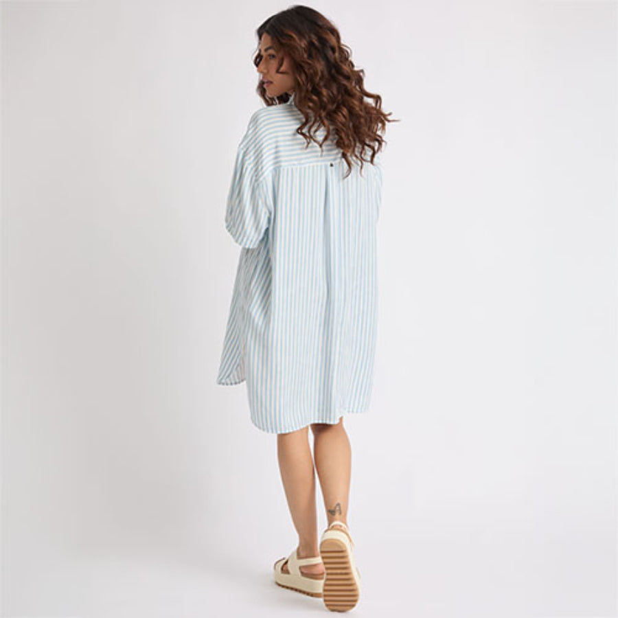 Woman wearing Ollie Striped Shirt Dress viewed from back, walking, showing comfort-focused footwear facing right side.
