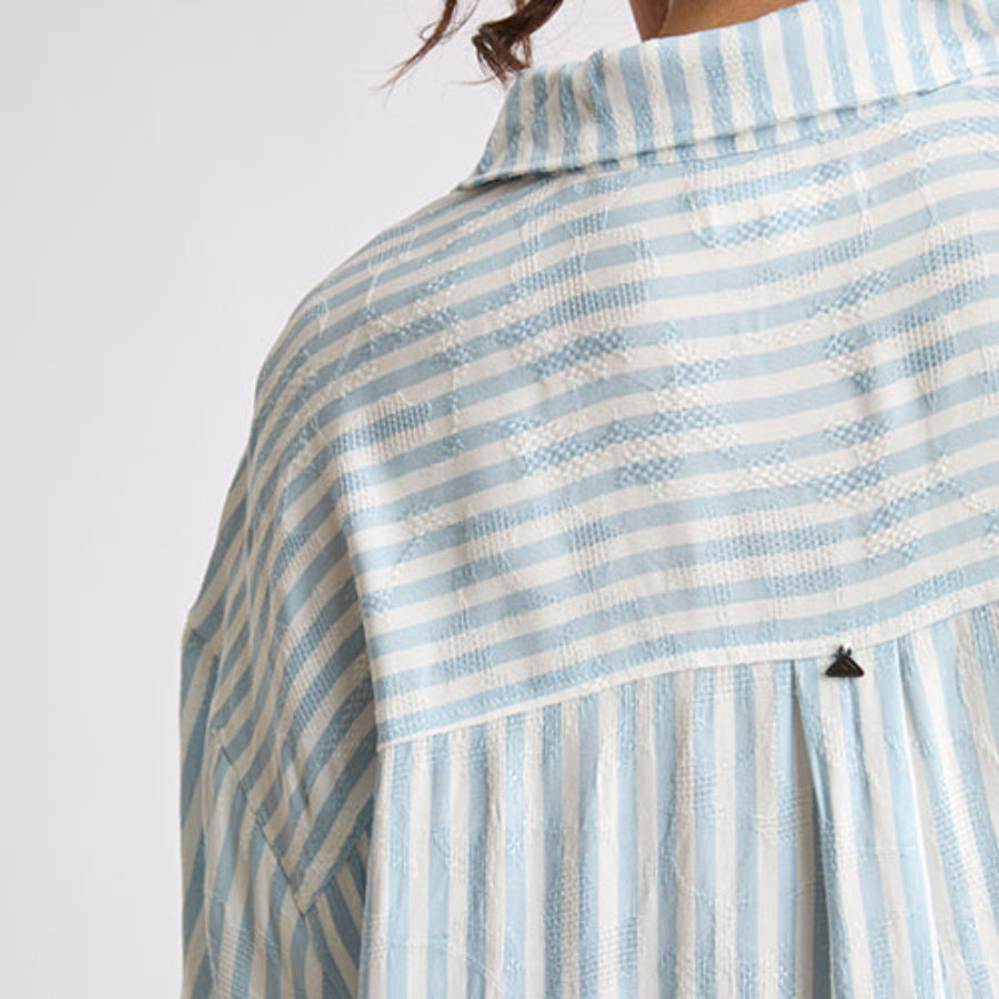 Back view close-up of light blue and white striped fabric on the Ollie Striped Shirt Dress, highlighting texture and collar.
