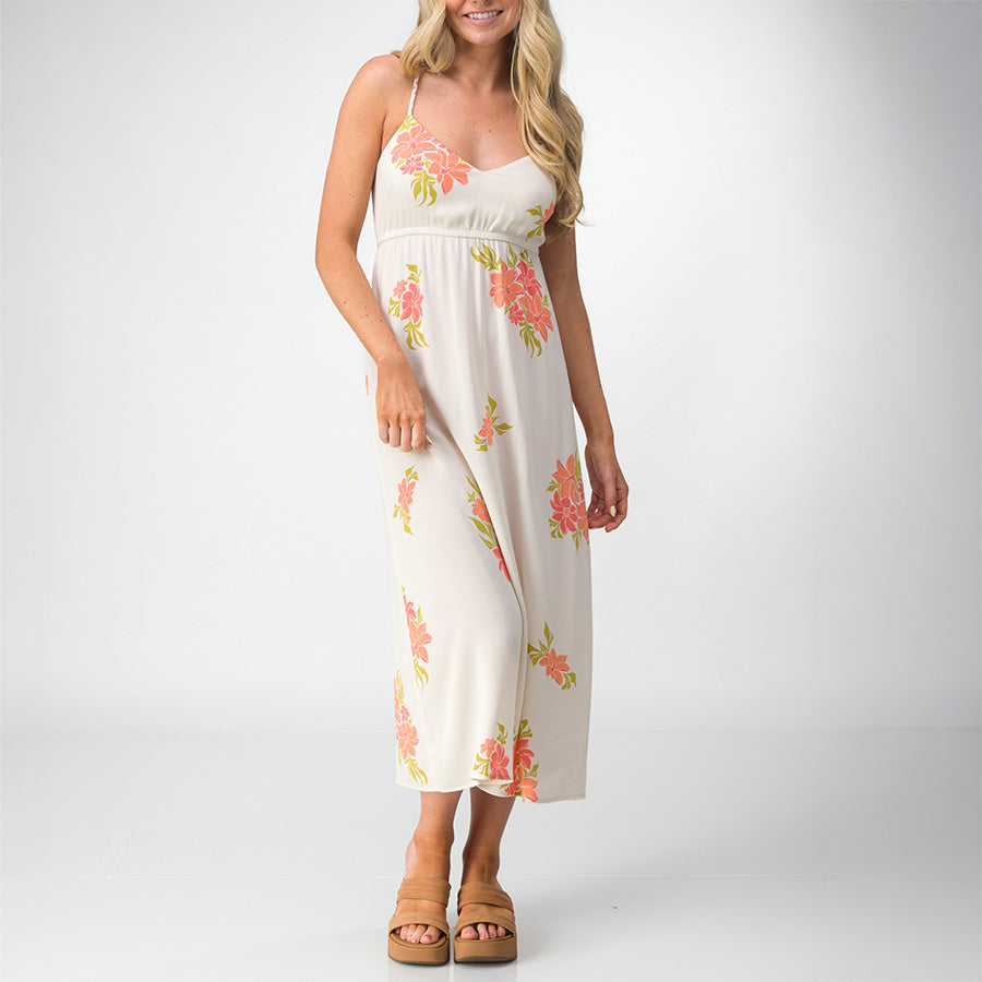 Woman wearing Belladona Dress with floral print paired with tan platform sandals facing forward, showcasing beach-inspired comfort.