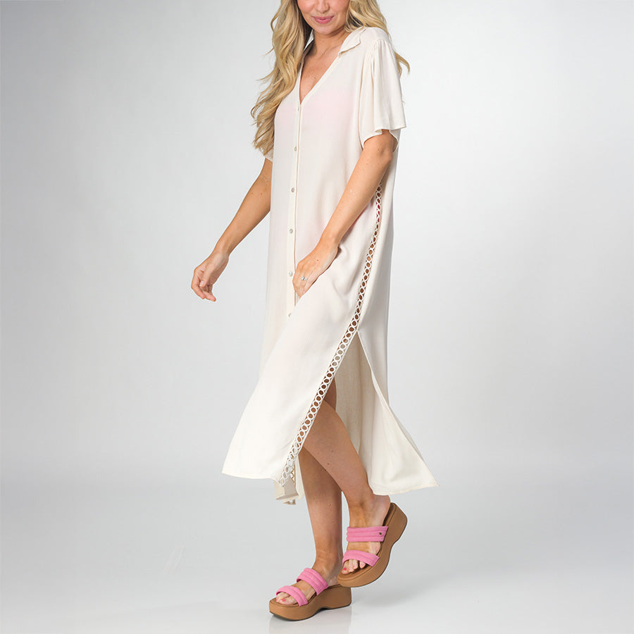 Woman wearing Irina Shirt Dress in light beige side view, paired with pink platform sandals facing left, showcasing comfort and beach style.