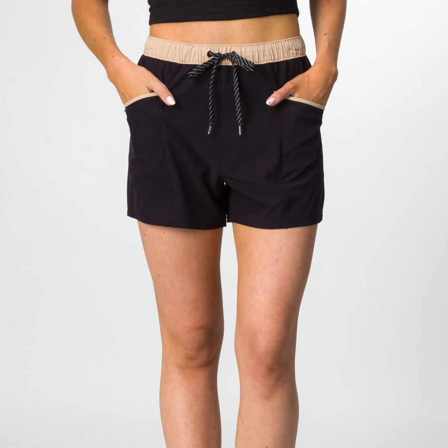 Front view of women's Robyn Short in black with beige waistband and drawstring, showcasing casual beach comfort style.