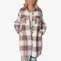 Woman wearing a front-facing Victoria Shacket in white and brown plaid, hands in side pockets, styled with ripped jeans and a light top.